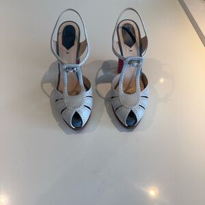 Fendi T-strap peep-toe slingback heels.
Light baby blue with pink accents